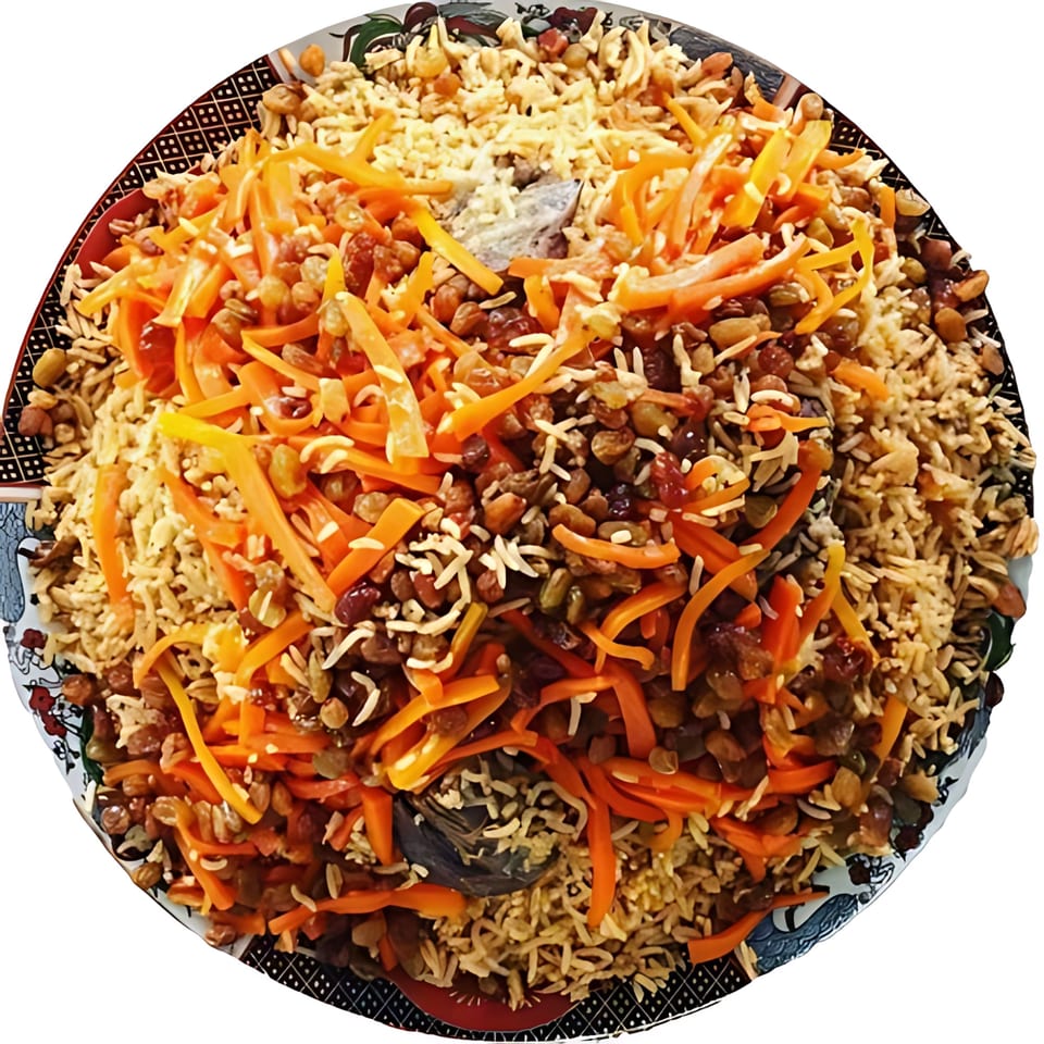 A large platter of Afghan Qabuli Palaw, featuring rice, carrots, and raisins.