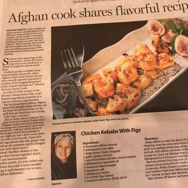 Afghan chicken kebabs with fresh figs and red onion on a white plate, with a fork.
